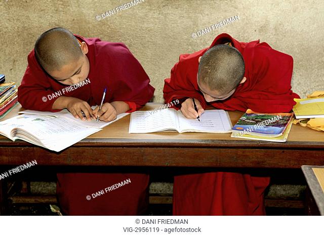 Young monks studying in a monastery classroom at the Ka-Nying Shedrub Ling Monastery in Kathmandu, Nepal. They are learning to become Buddhist monks