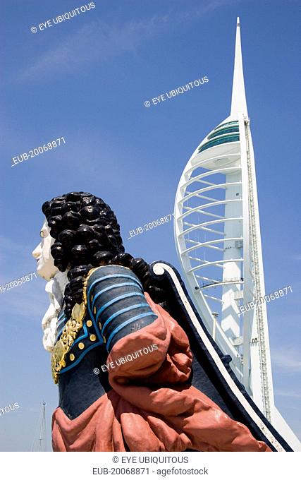 The Spinnaker Tower the tallest public viewing platforn in the UK at 170 metres on Gunwharf Quay with old ships bowsprit figurehead in the foreground