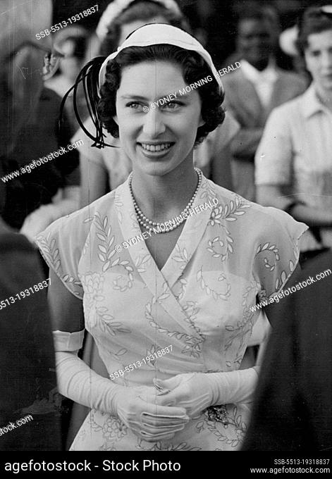 Princess Margaret elegant in a beige and flowered dress, photographed as she walks in the grounds of Government House during her visit to the Caribbean island...