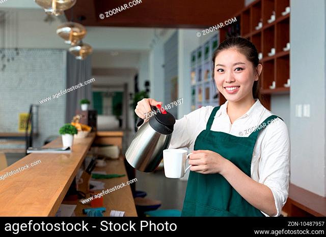young beautiful woman works near counter in cafe