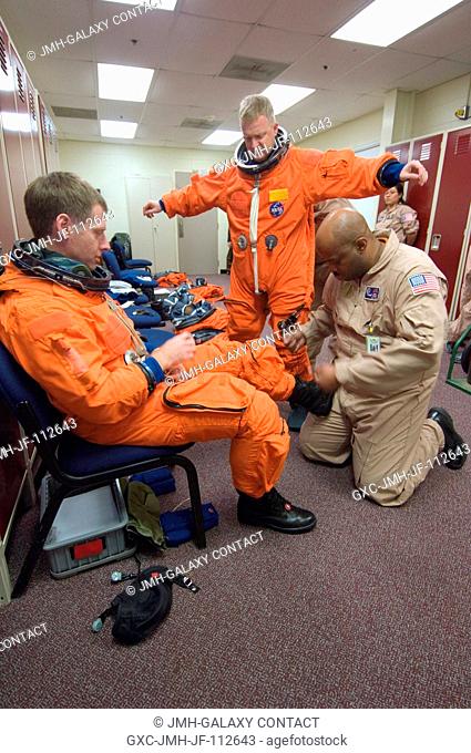 Astronauts Christopher J. Ferguson (left) and Eric A. Boe, STS-126 commander and pilot, respectively, don training versions of their shuttle launch and entry...