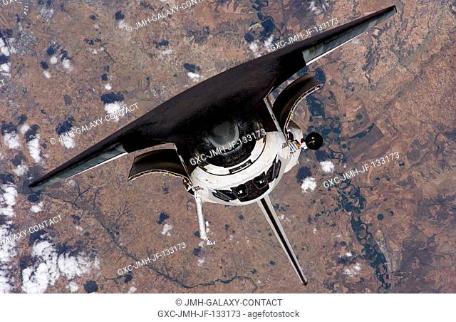 The Space Shuttle Discovery approaches the International Space Station for docking, but before the link-up occurred the orbiter posed for a thorough series of...