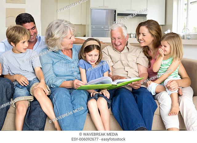 Family reading storybook in living room