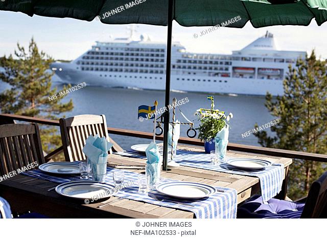 Table with cruise liner in background