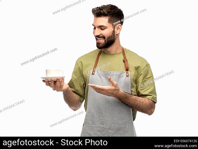 happy smiling waiter in apron with cup of coffee