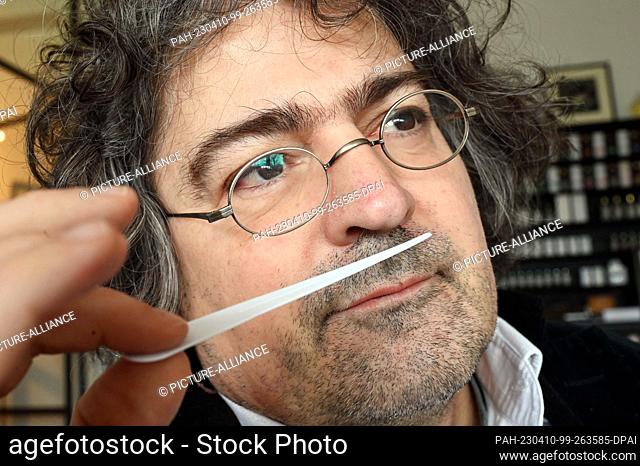 PRODUCTION - 03 April 2023, Baden-Württemberg, Karlsruhe: Perfumer Roland Tentunian takes a scent sample of a developed perfume recipe in his company Florascent...