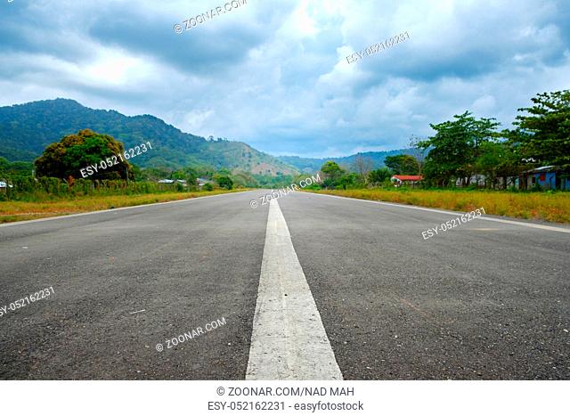 straight asphalt road in rural landscape - empty runway -