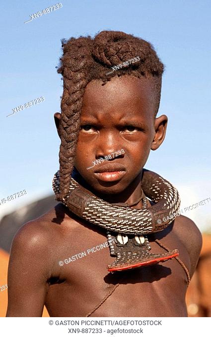 Himba boy with the typical double plait hairstyle, Epupa falls, Kaokoland, Namibia