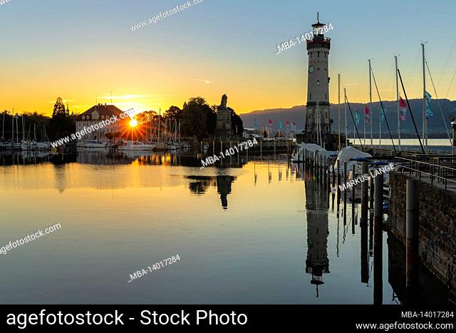 lindau harbor with lighthouse at sunrise, lake constance, bavaria, germany