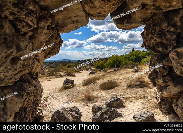 View through stone arch in Pobiti Kamani rock formations called Stone Desert in Bulgaria