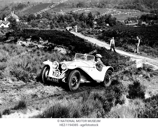 1935 Riley Imp 9hp competing in the Lawrence Cup Trial. The car climbs a steep track with two marshals watching from below