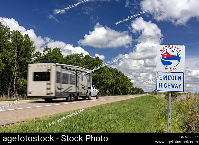 Car with caravan, trailer, on Lincoln Highway, road sign near Hershey, Nebraska Byway, Nebraska, USA, North America