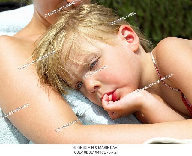 Girl resting on her mother, heat