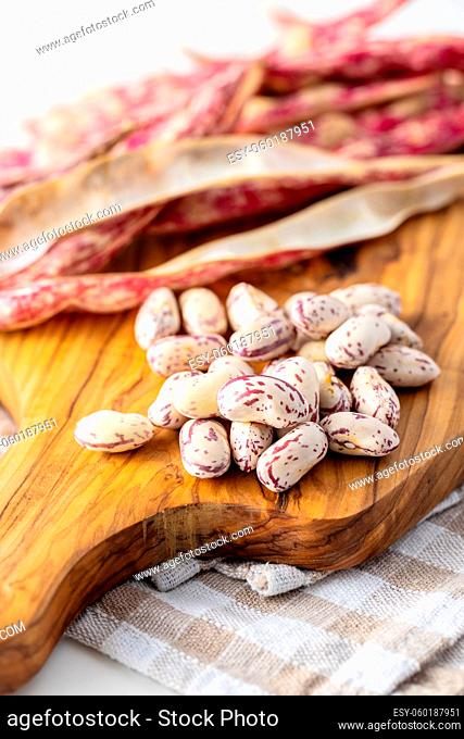 Cranberry beans. Beans pods on cutting board