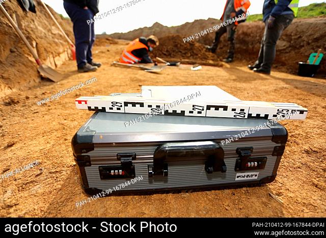09 April 2021, Saxony-Anhalt, Derenburg: A measuring stick lies on a case at the archaeological site. Archaeological investigations are currently being carried...