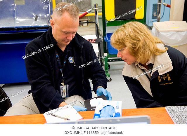 NASA astronauts Doug Hurley, STS-135 pilot; and Sandy Magnus, mission specialist, participate in an EVA Thermal Protection System (TPS) overview training...