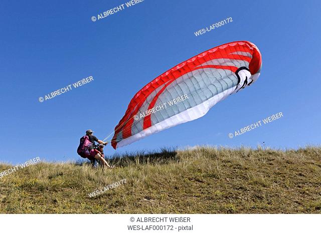 France, Bretagne, Landeda, Father and son with paraglider in dune