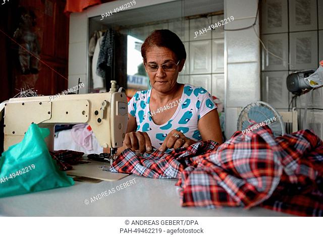 A woman sews in her shop in a village near Porto Seguro in Brazil, 09 June 2014. The German national soccer team stays in a hotel near Porto Seguro during the...