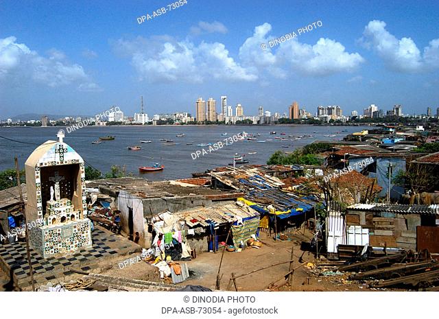 Worli village temple and houses of urban poor with rich houses behind in , Mumbai Bombay , Maharashtra, India