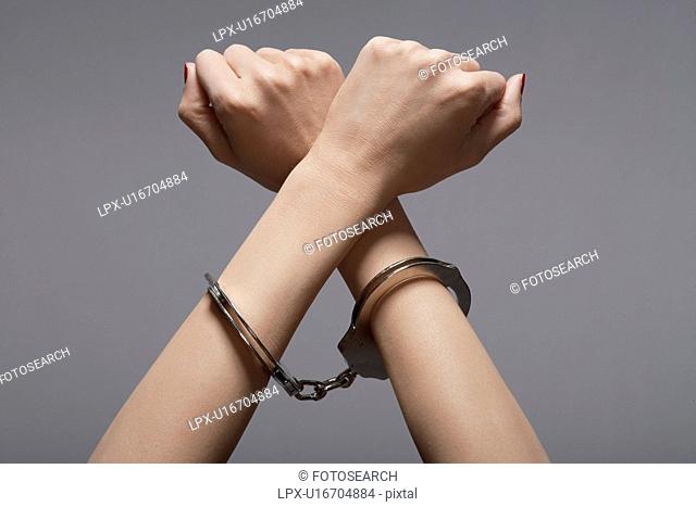 Woman's hands in handcuffs close-up