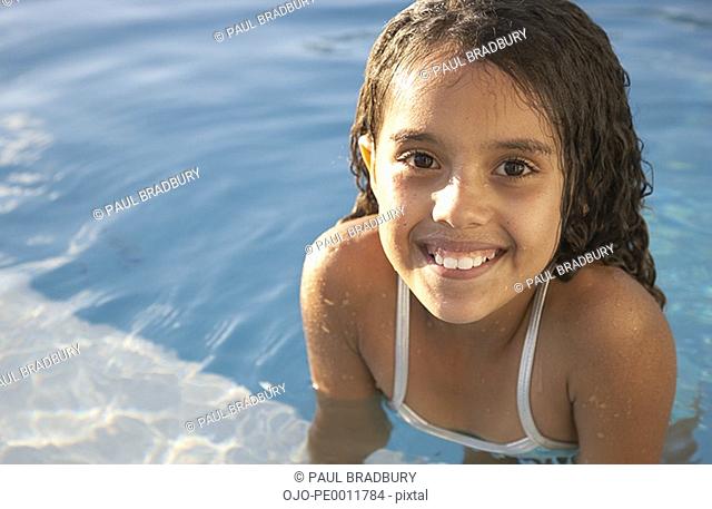 Girl in pool smiling