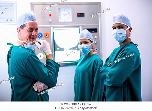 Surgeons discussing a report on surgical monitor in operation room