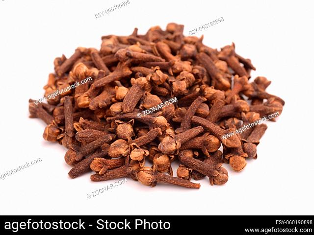Heap of dried buds of clove isolated on white