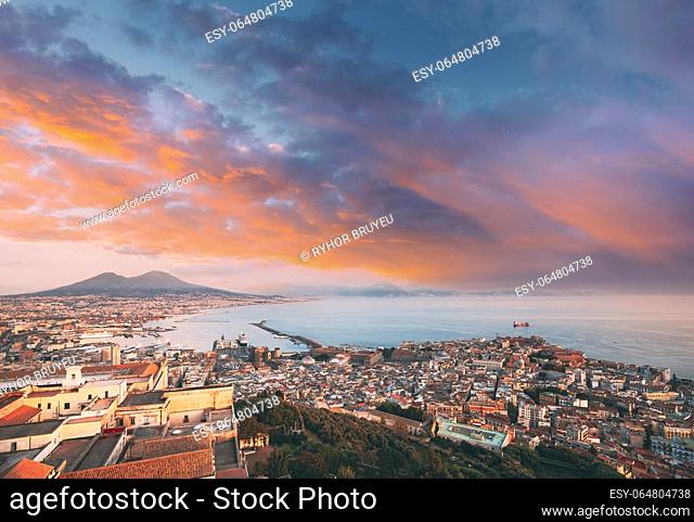 Naples, Italy. Top View Skyline Cityscape City In Evening Sunset. Tyrrhenian Sea And Landscape With Volcano Mount Vesuvius