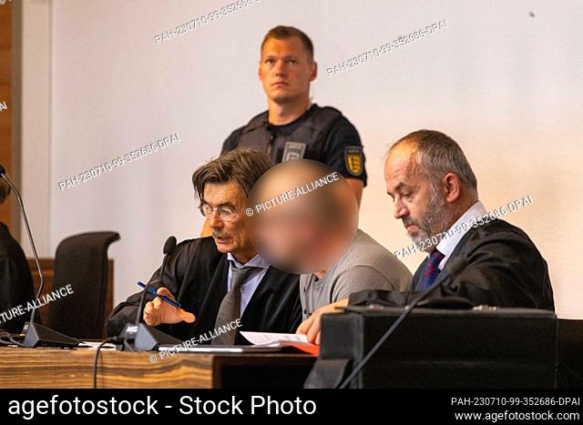 10 July 2023, Baden-Württemberg, Freiburg: A defendant talks to his defense lawyers. The 63-year-old is accused of attacking his former girlfriend and her...