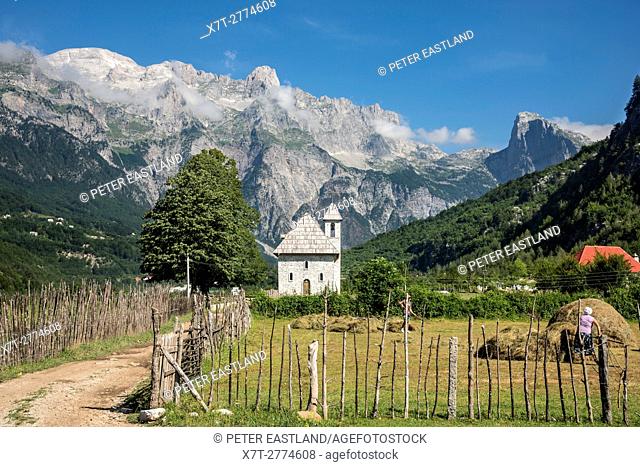 Looking across the village of Theth with its shingle roofed church and the Albanian Alps, Radohima massif and Mount Arapit in the background, Northern Albania