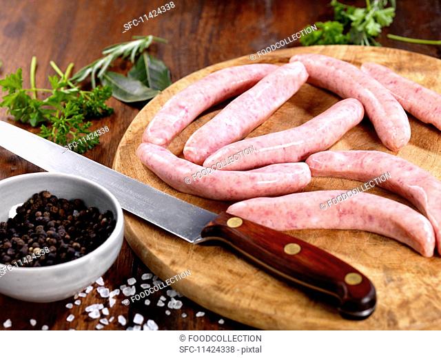 sausages on a chopping board with ingredients