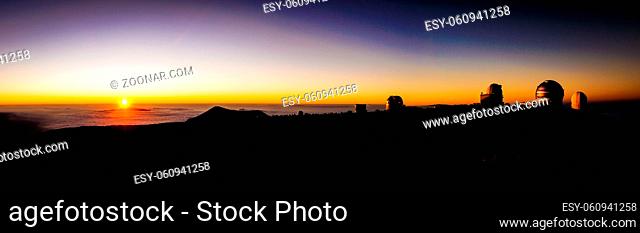 View from Mauna Kea, Big Island, Hawaii, USA at sunset on observatories and clouds of Hawaii