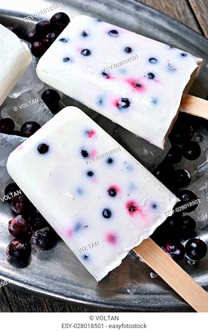 Homemade popsicles from yogurt, blueberry and blackcurrant, close up view