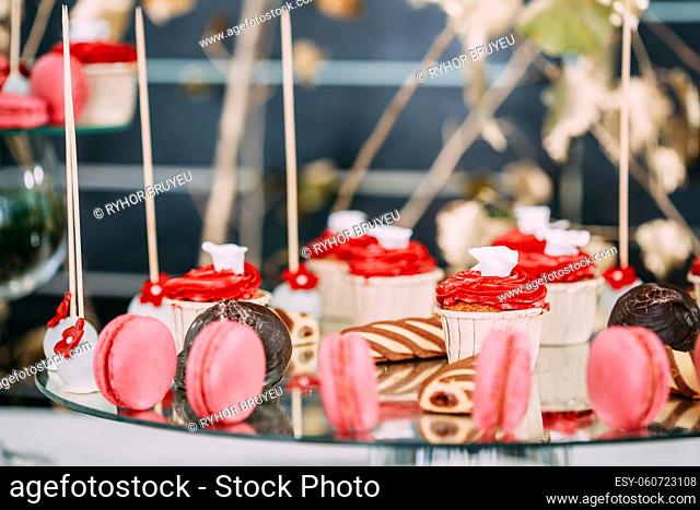 Dessert Sweet Tasty Cupcakes, Macarons And Cookies In Candy Bar On Table. Delicious Sweet Buffet. Wedding Holiday Decorations