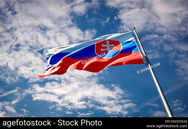 Beautiful national state flag of Slovakia fluttering at sky background. Low angle close-up Slovakia flag 3D artwork