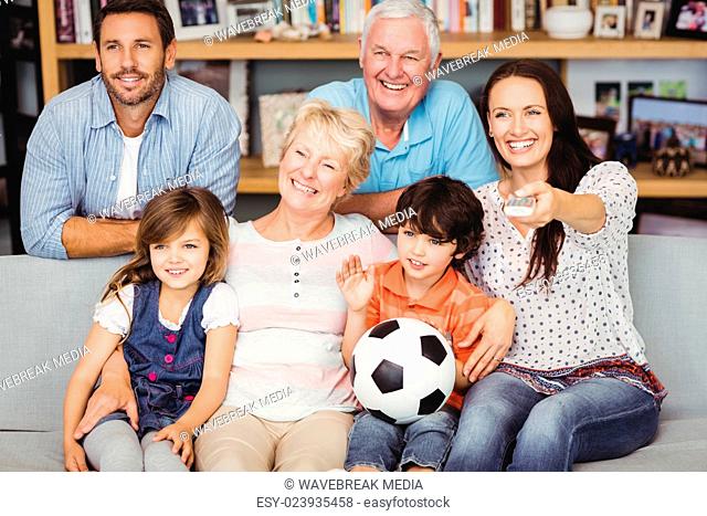 Smiling family watching football match