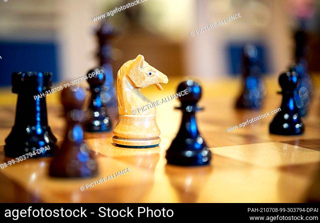01 July 2021, Lower Saxony, Wardenburg: Wooden chess pieces stand on a chess board. Chess is a strategic board game in which two players take turns moving chess...