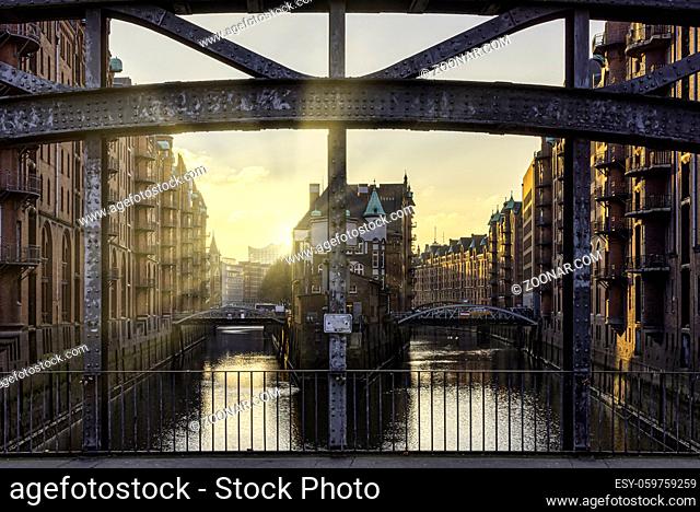 sunset above canal in historic warehouse district Speicherstadt in Hamburg, Germany