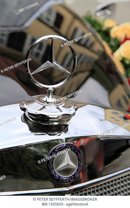 Mercedes star emblem on vintage Mercedes Benz 300 car with wedding decorations