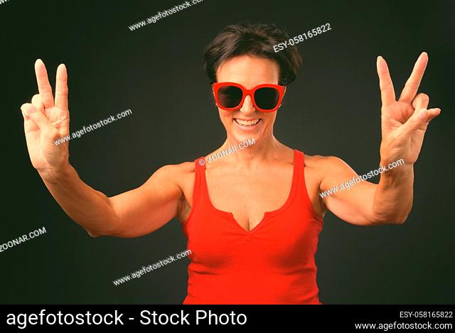 Studio shot of mature beautiful Scandinavian woman with short hair against black background