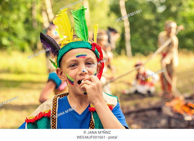 Germany, Saxony, Indians and cowboy party, Boy eating roasted marshmallow