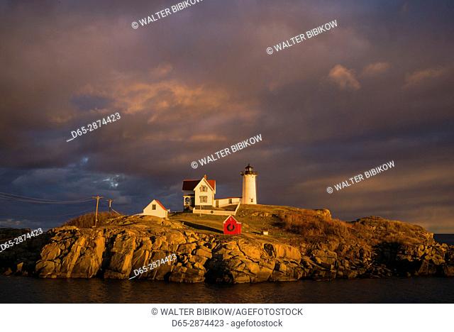 USA, Maine, York Beach, Nubble Light Lighthouse with Christmas decorations, sunset