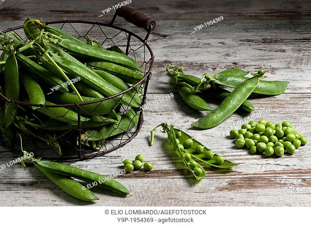 Pea Pods and Shelled Peas on Wooden Table