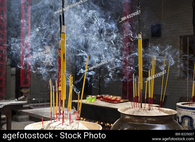 Incense sticks burning on incense pot, smoke used to pay respect to the Buddha at Chua Thien Hau Temple, Ho Chi Minh City, Saigon, Southeast Asia, Vietnam, Asia