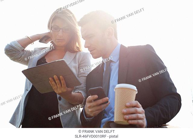 Businesspeople using tablet computer