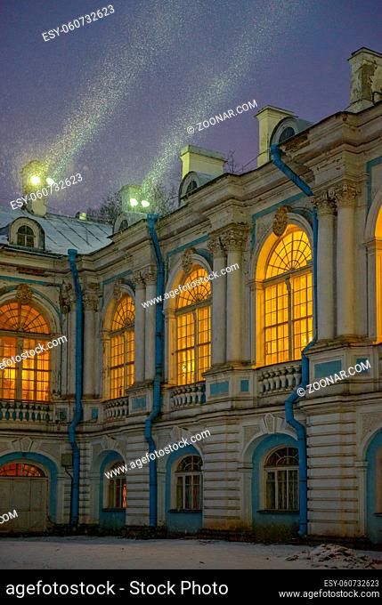 Smolny Convent with night illumination in St. Petersburg, Russia. Spotlights on the roof shine through snowfall