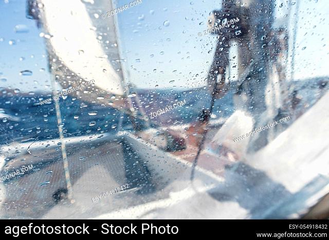 Sailing yacht catamaran sailing in rough sea. Sailing. Sailboat concept. Narrow depth of field image focused on water drops on splash protective canvas