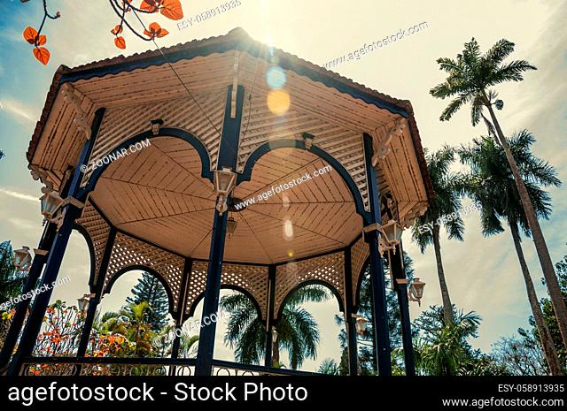 Close-up of colorful gazebo ceiling in the middle of garden full of trees, in sunny day at São Manuel. A cute little town in the countryside of São Paulo State