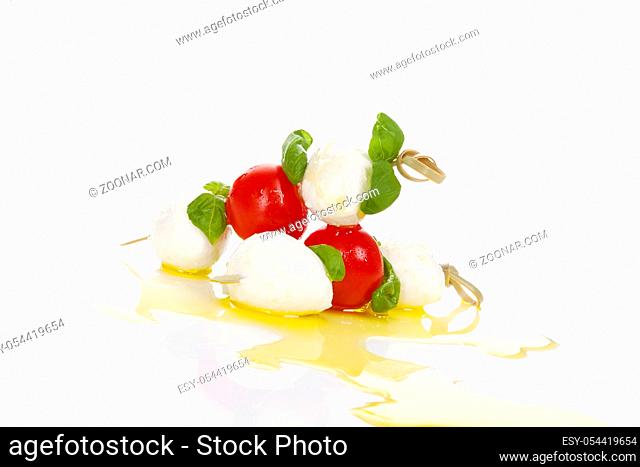 Delicious fresh caprese. Mozzarella cheese, fresh basil and cherry tomatoes with extra virgin olive oil. Traditional italian eating
