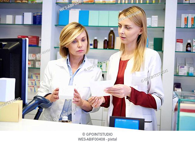 Two pharmacists working together in pharmacy
